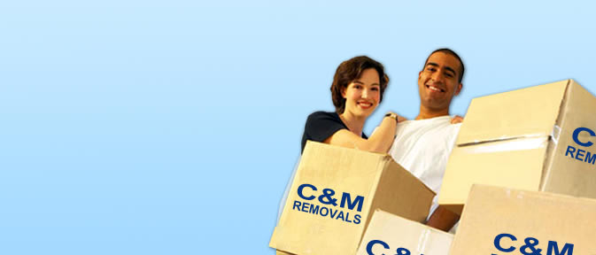 Man and woman with C&M removal boxes after a move to a new home